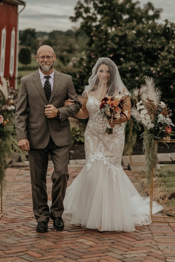 Bride (Samatha) and father with bouquet.